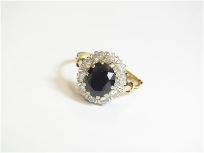 Lot 75 - A sapphire and diamond cluster ring