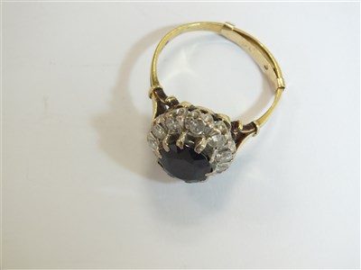 Lot 75 - A sapphire and diamond cluster ring