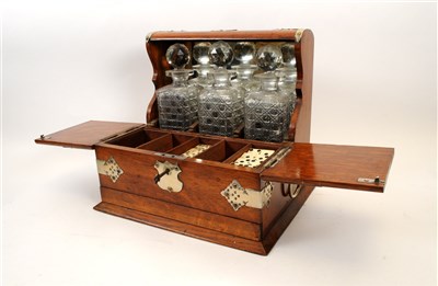 Lot 716 - A Victorian oak three decanter tantalus with silver-plated mounts and an oak drinks tray