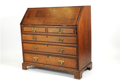 Lot 779 - A George III country oak cross-banded bureau