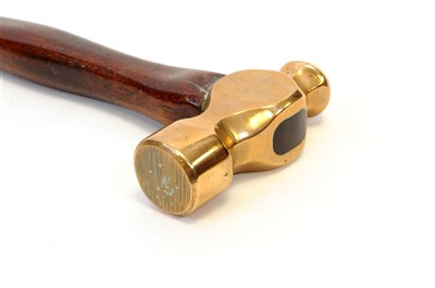 Lot 540 - An early 20th century bronze headed hammer with a shaped mahogany handle