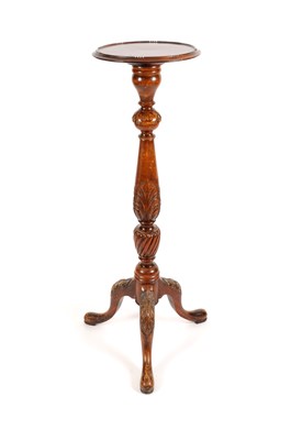 Lot 737 - A carved mahogany jardinière stand