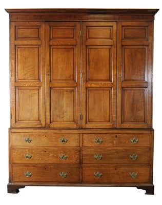 Lot 766 - A large and impressive George III country house cross-banded oak livery cupboard