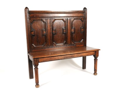 Lot 287 - A small 18th century and later country oak panelled settle