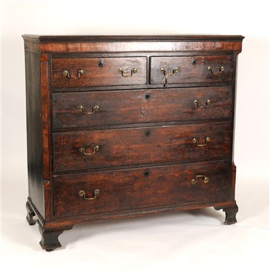 Lot 674 - A large George III country oak chest of two short and three long drawers