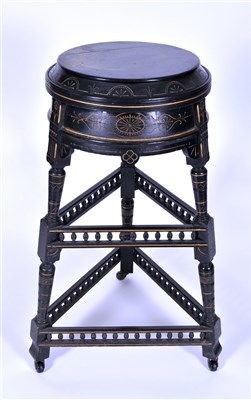 Lot 126 - An aesthetic movement ebonised and veneered carved single tier jardinere stand