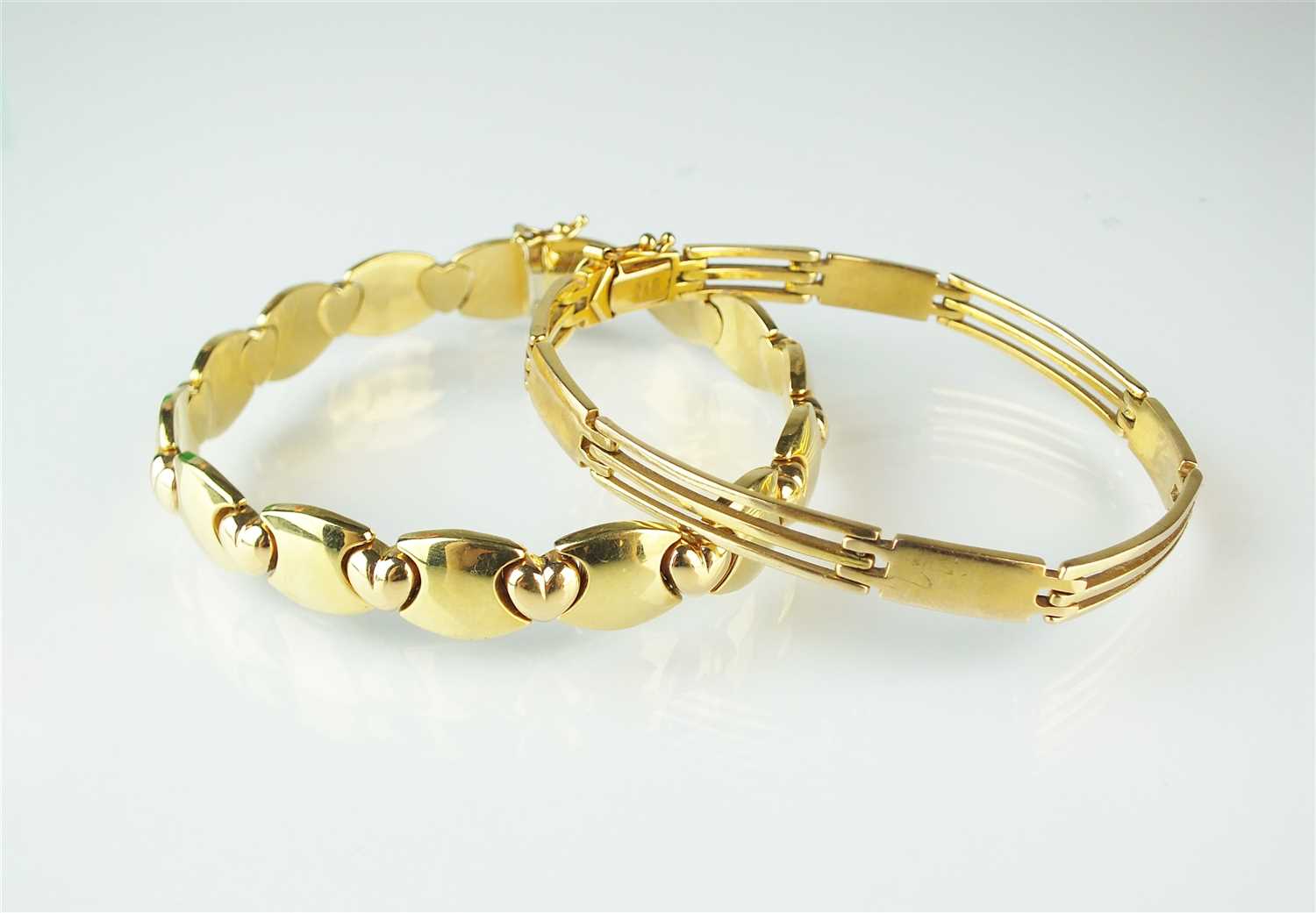 Lot 304 - Two yellow metal bracelets