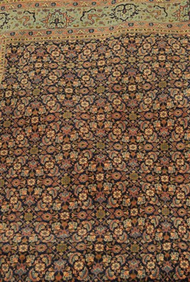 Lot 828 - A Feraghan carpet fragment, the indigo field...