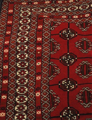 Lot 831 - An Afghan Turkmen rug, the blood red field of...