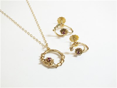 Lot 121 - A 9ct gold ruby set pendant and earrings