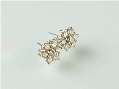 Lot 260 - A pair of 18ct white gold diamond floral cluster earrings