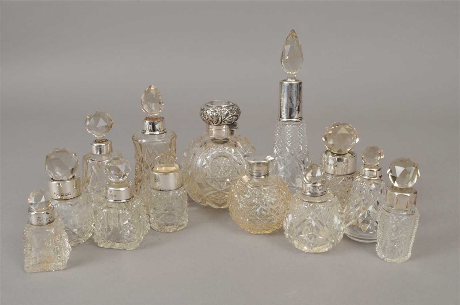 Lot 64 - A collection of silver mounted glass dressing table jars/bottles
