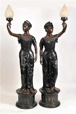 Lot 334 - A very large and impressive pair of figural hollow cast bronze floor-standing lamps