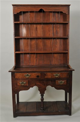 Lot 350 - A George III country oak dresser of small proportions and an associated oak dresser / delft rack