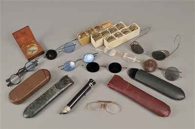 Lot 245 - A collection of Victorian and later spectacles, a pocket magnifier and a small cased compass