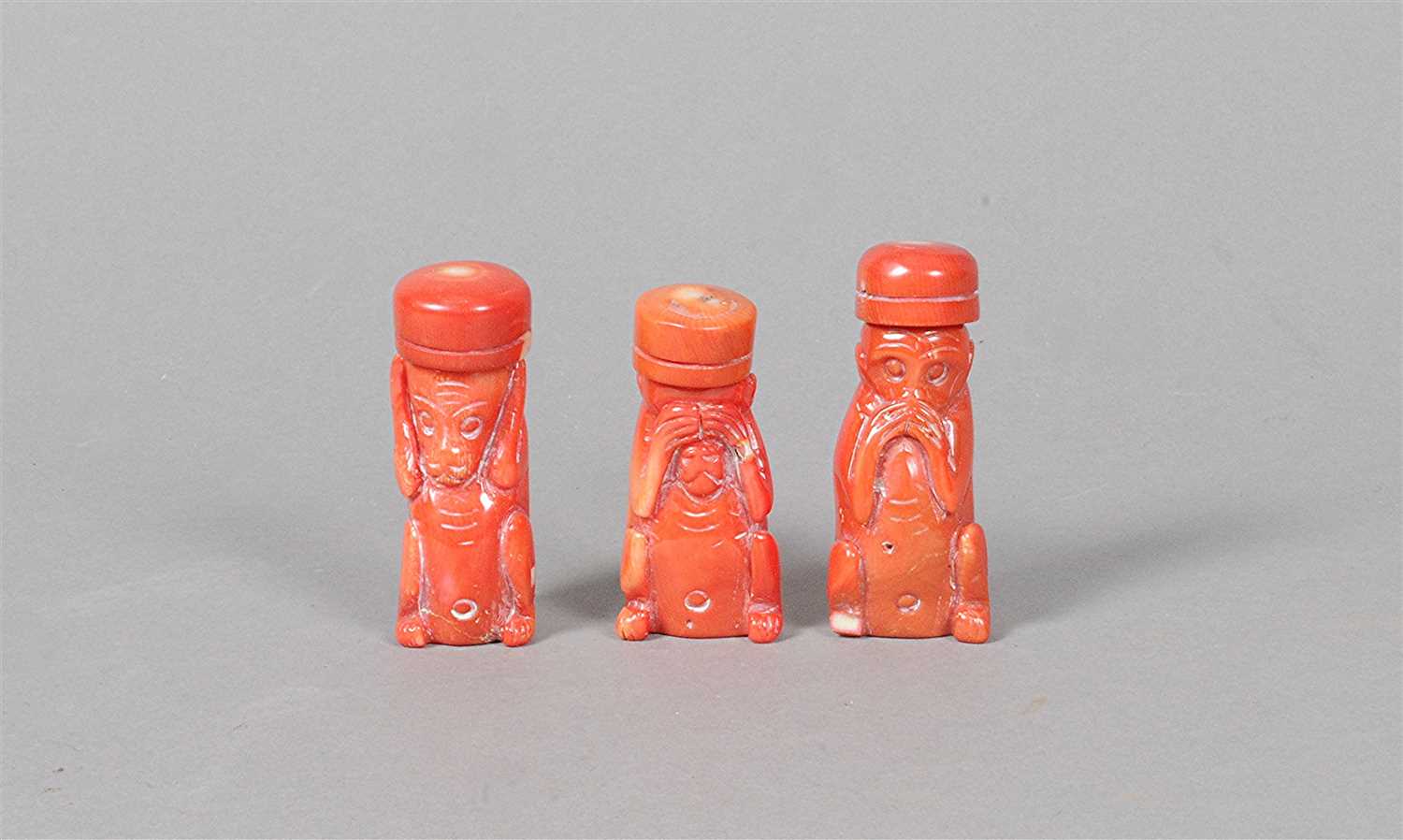 Lot 3 - A trio of Chinese carved coral flasks in the form of monkeys