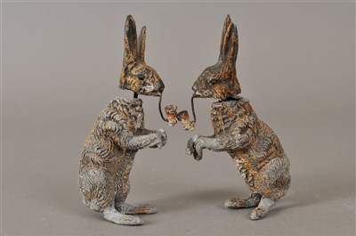 Lot 243 - A novelty pair of painted cast metal figures of hares