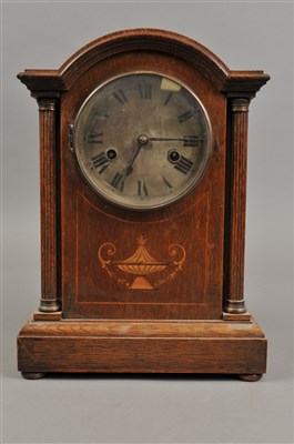 Lot 318 - An inlaid oak cased H.A.C brand mantle clock and a continental poreclain cased mantle clock