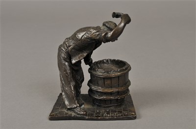 Lot 269 - A small cast bronze study of an early 20th century workman cooppering