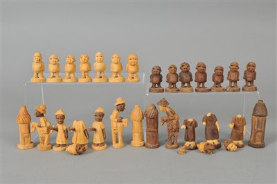 Lot 334 - An African export carved wooden chess set and a carved wooden tribal figure.