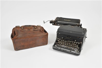 Lot 341 - An Edwardian leather gladstone bag and a Remington type writer.