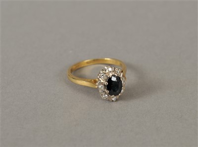 Lot 66 - An 18ct gold sapphire and diamond oval cluster ring