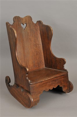 Lot 480 - A child's early 20th century oak rocking chair