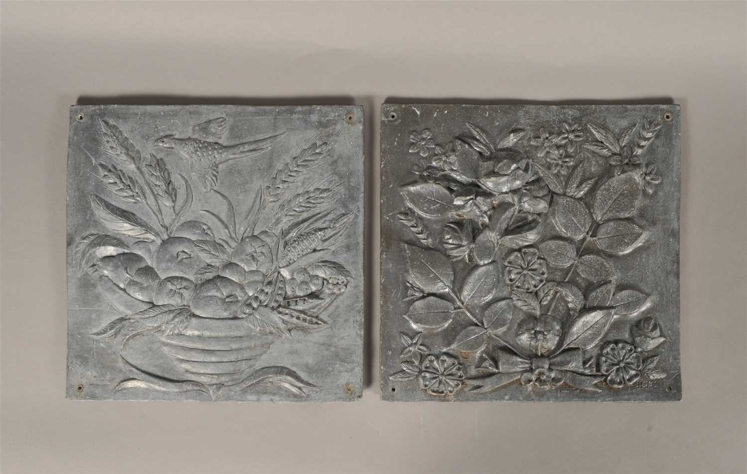 Lot 275 - A decorative pair of moulded lead panels of square form