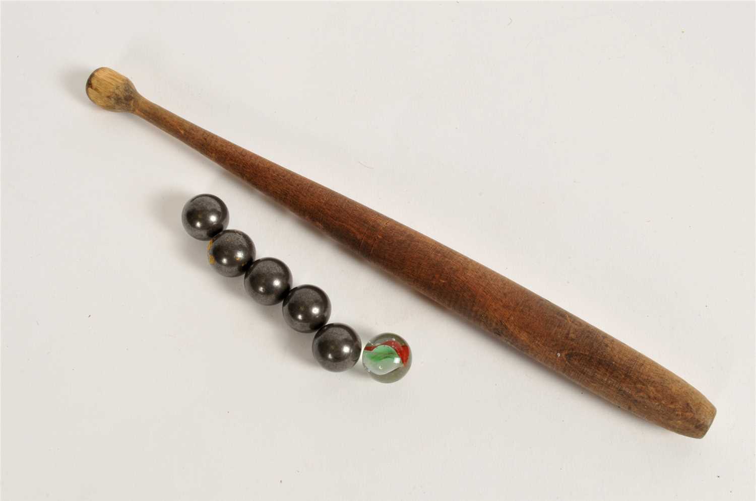 Lot 297 - A 20th century bagatelle board together with pusher and associated balls.