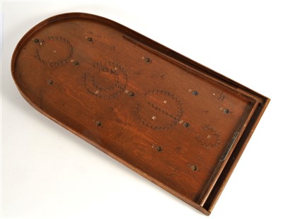 Lot 297 - A 20th century bagatelle board together with pusher and associated balls.