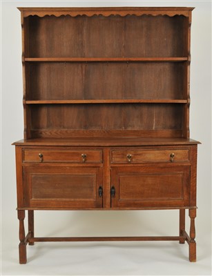 Lot 588 - A George III style stained oak kitchen dresser