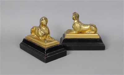 Lot 215 - A pair of 19th century ormolu seated sphinxes