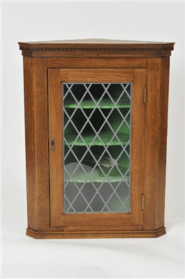 Lot 433 - A Georgian style stained oak corner cupboard