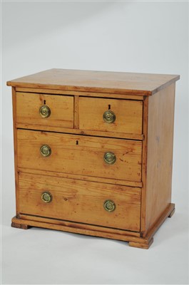 Lot 455 - A small rustic pine chest of two short and two long drawers