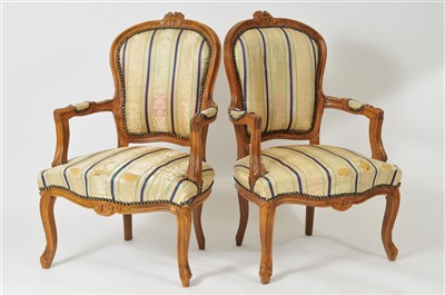 Lot 441 - A pair of French carved walnut upholstered armchairs