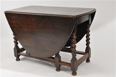 Lot 607 - A stained oak gateleg dining table