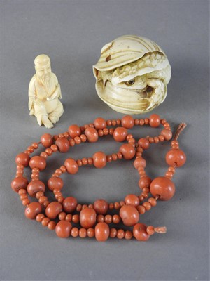 Lot 122 - A Chinese string of coral beads, Qing Dynasty,...