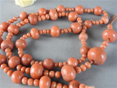 Lot 122 - A Chinese string of coral beads, Qing Dynasty,...