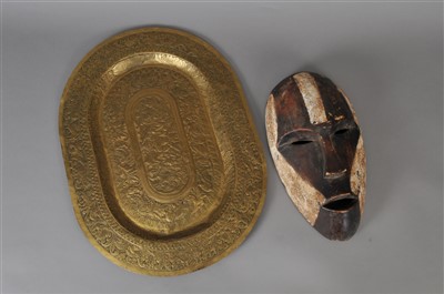 Lot 263 - A 19th century Indian brass tray and a African tribal mask