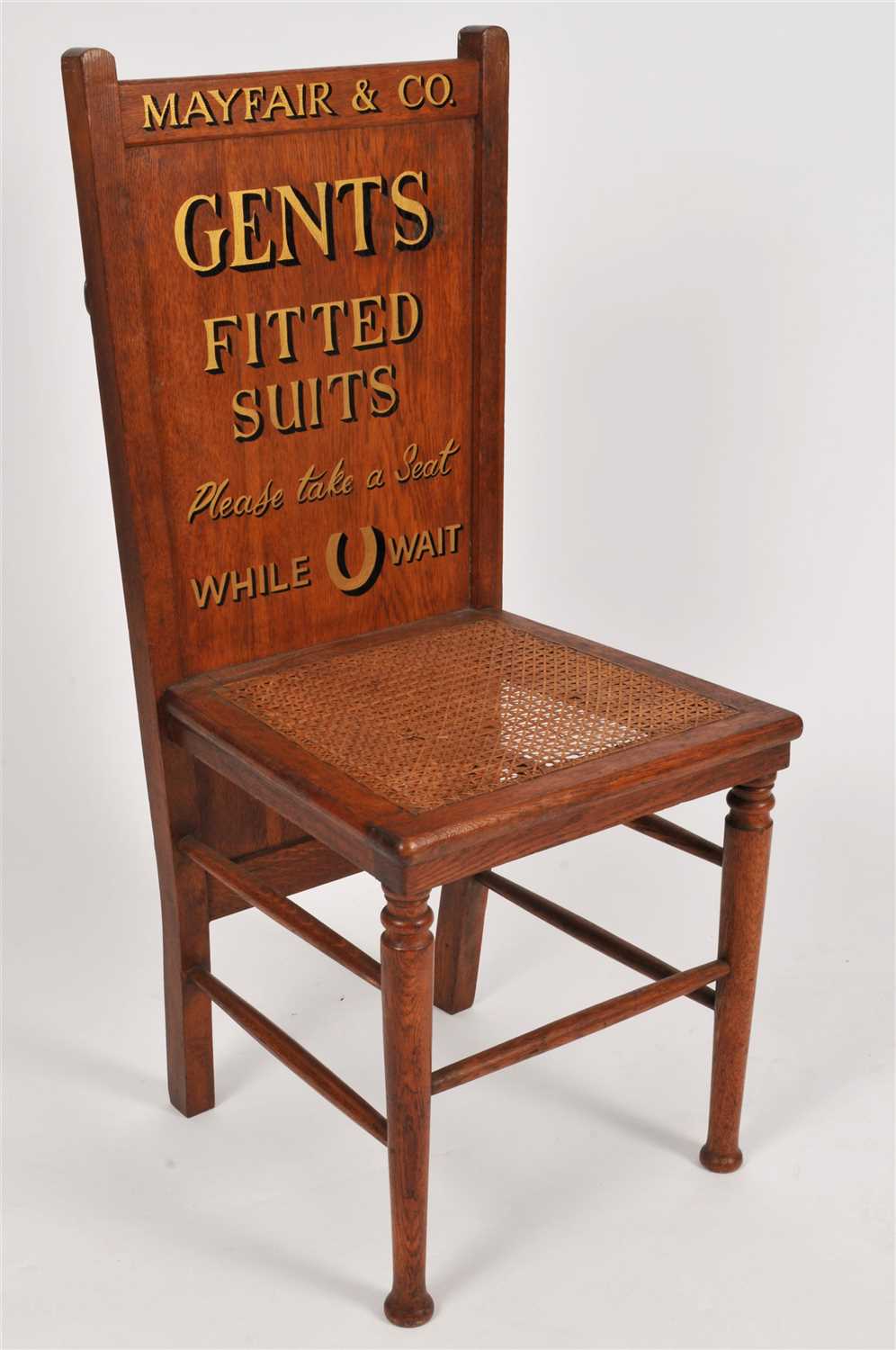 Lot 786 - An Edwardian pale oak tailor's shop advertising chair