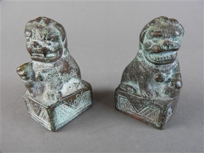 Lot 527 - A small pair of Chinese bronze lion dog scroll...