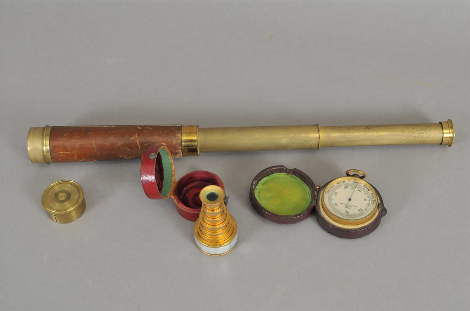 Lot 733 - A cased pocket barometer by Negretti & Zambra and two telescopes