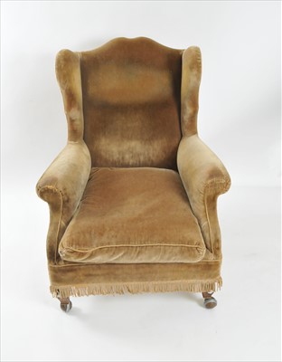 Lot 323 - A 19th century upholstered wing armchair
