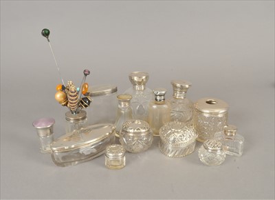 Lot 52 - A collection of twelve silver topped glass dressing table jars/bottles