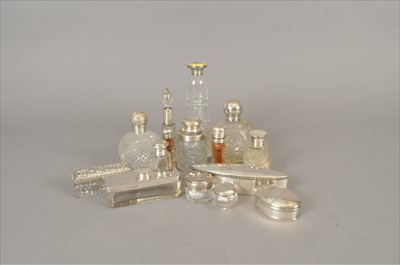 Lot 53 - A collection of twelve silver topped glass dressing table jars/bottles