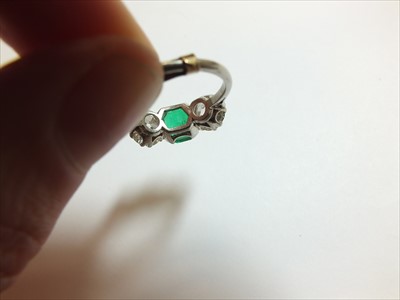 Lot 59 - A three stone emerald and diamond ring