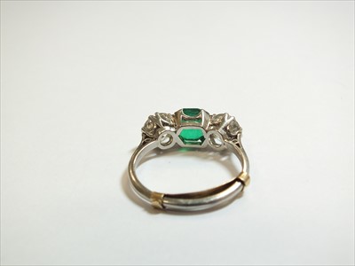 Lot 59 - A three stone emerald and diamond ring