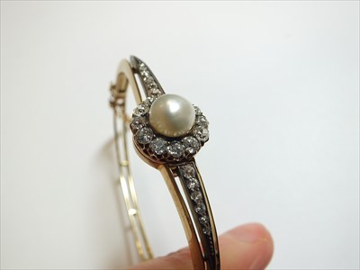 Lot 60 - A late 19th century untested pearl and diamond hinged bangle