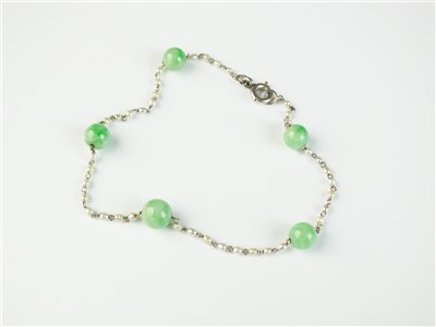 Lot 91 - A jade and seed pearl set bracelet