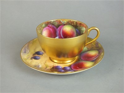 Lot 231 - Royal Worcester fruit-decorated teacup and saucer